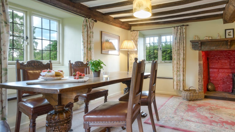 The dining table in the sitting and dining room at Broad Ley Cottage, Devon
